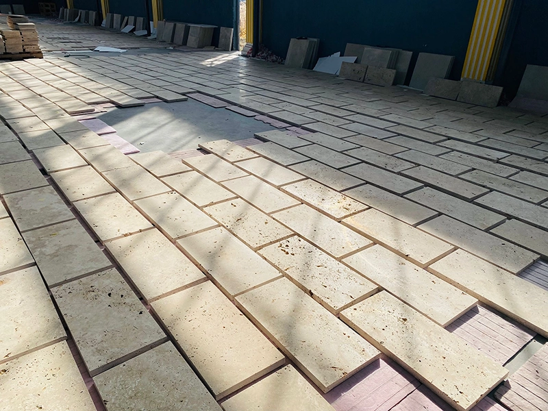 Natural stone tiles dry-laid in production facility to verify color flow and texture consistency under Como Tiles Quality Assurance Protocol